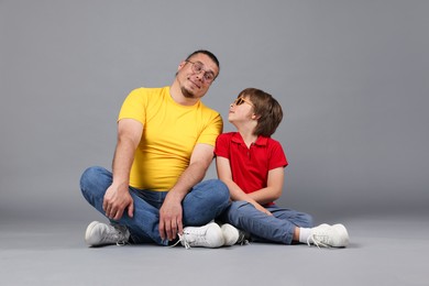 Photo of Father and his son on grey background