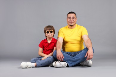 Photo of Father and his son on grey background