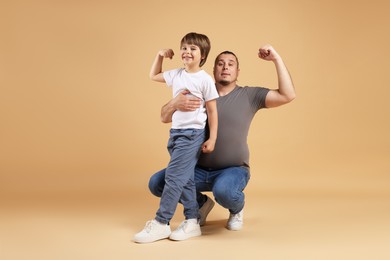 Photo of Father and his son on beige background
