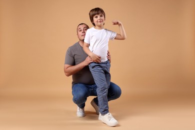 Photo of Father and his son on beige background