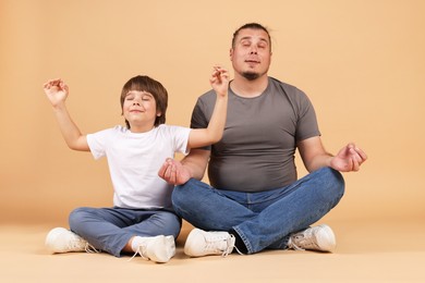Photo of Father and his son on beige background