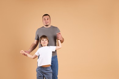 Photo of Father and his son on beige background
