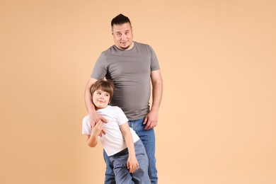 Photo of Father and his son on beige background