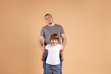 Photo of Father and his son on beige background