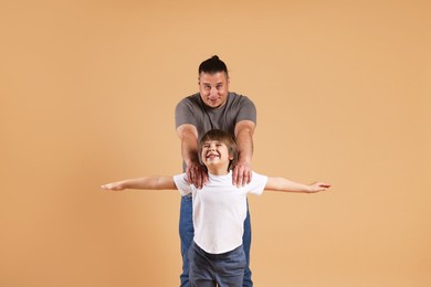 Photo of Father and his son on beige background