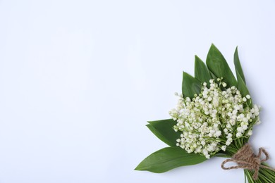 Photo of Beautiful lily-of-the-valley flowers on white background, top view. Space for text