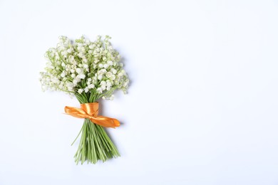 Photo of Beautiful lily-of-the-valley flowers on white background, top view. Space for text
