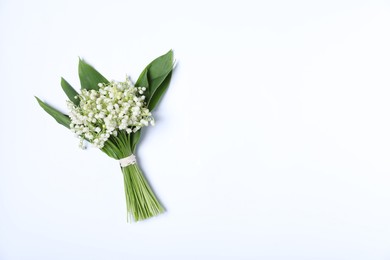 Photo of Beautiful lily-of-the-valley flowers on white background, top view. Space for text