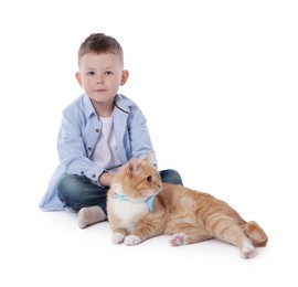 Photo of Little boy with her cute ginger cat on white background