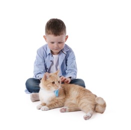 Photo of Little boy with her cute ginger cat on white background
