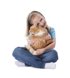 Photo of Little girl with her cute ginger cat on white background