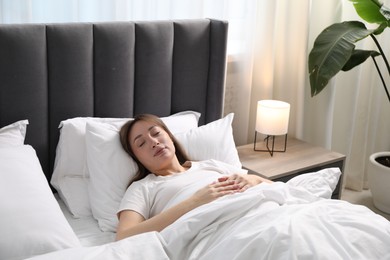 Photo of Beautiful woman sleeping in bed at home