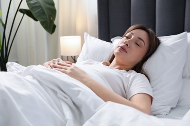 Photo of Beautiful woman sleeping in bed at home