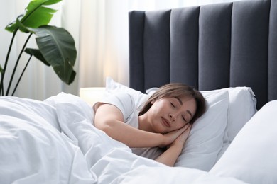 Photo of Beautiful woman sleeping in bed at home