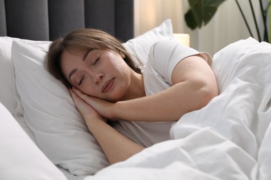 Photo of Beautiful woman sleeping in bed at home