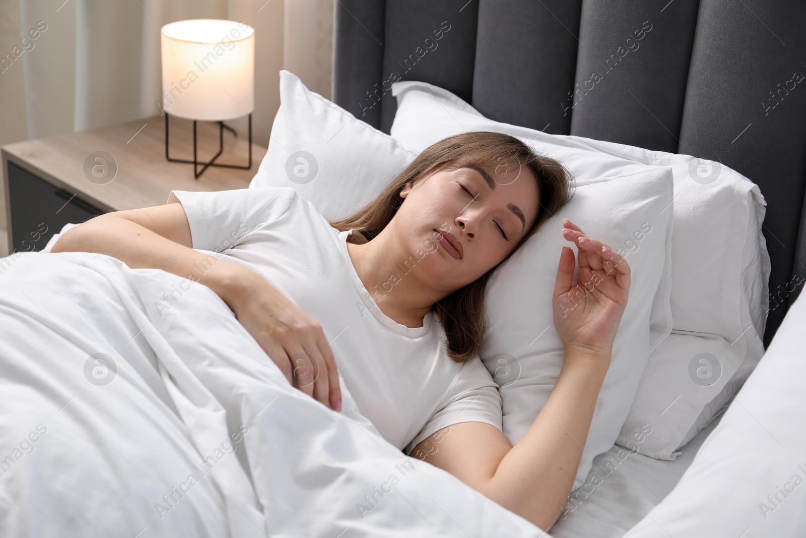 Beautiful woman sleeping in bed at home Photo of Beautiful woman sleeping in bed at home