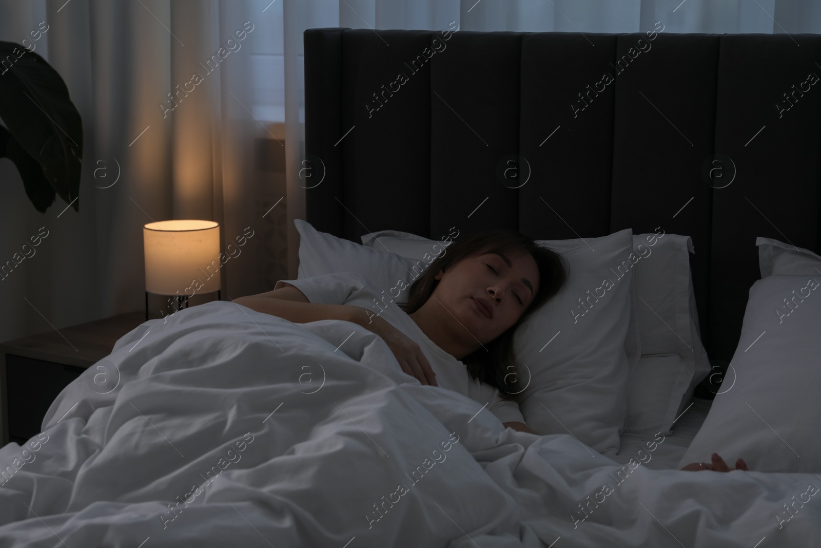 Beautiful woman sleeping in bed at home Photo of Beautiful woman sleeping in bed at home