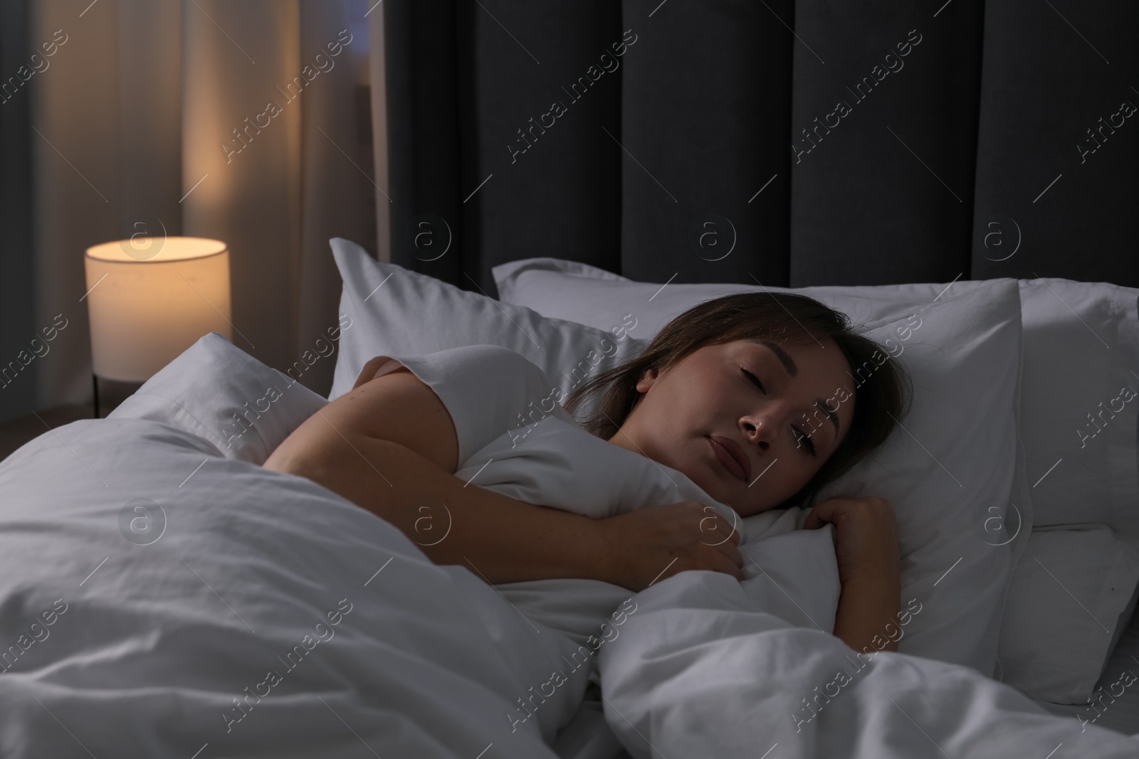Photo of Beautiful woman sleeping in bed at home
