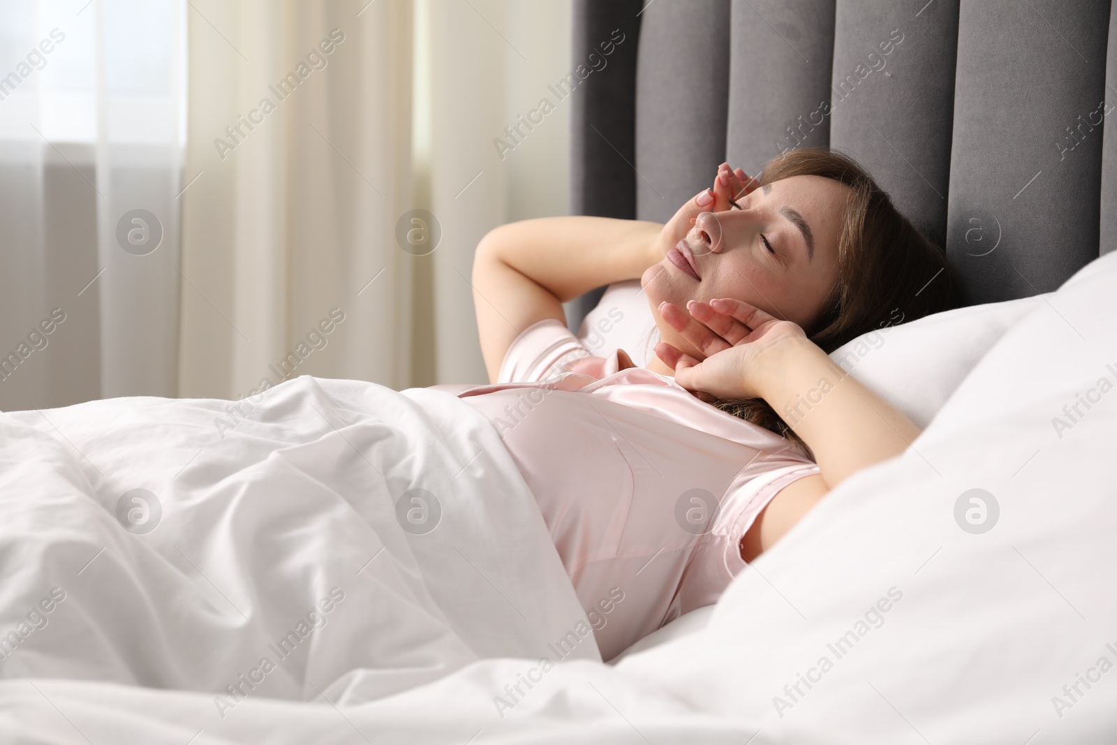 Beautiful woman sleeping in bed at home Photo of Beautiful woman sleeping in bed at home
