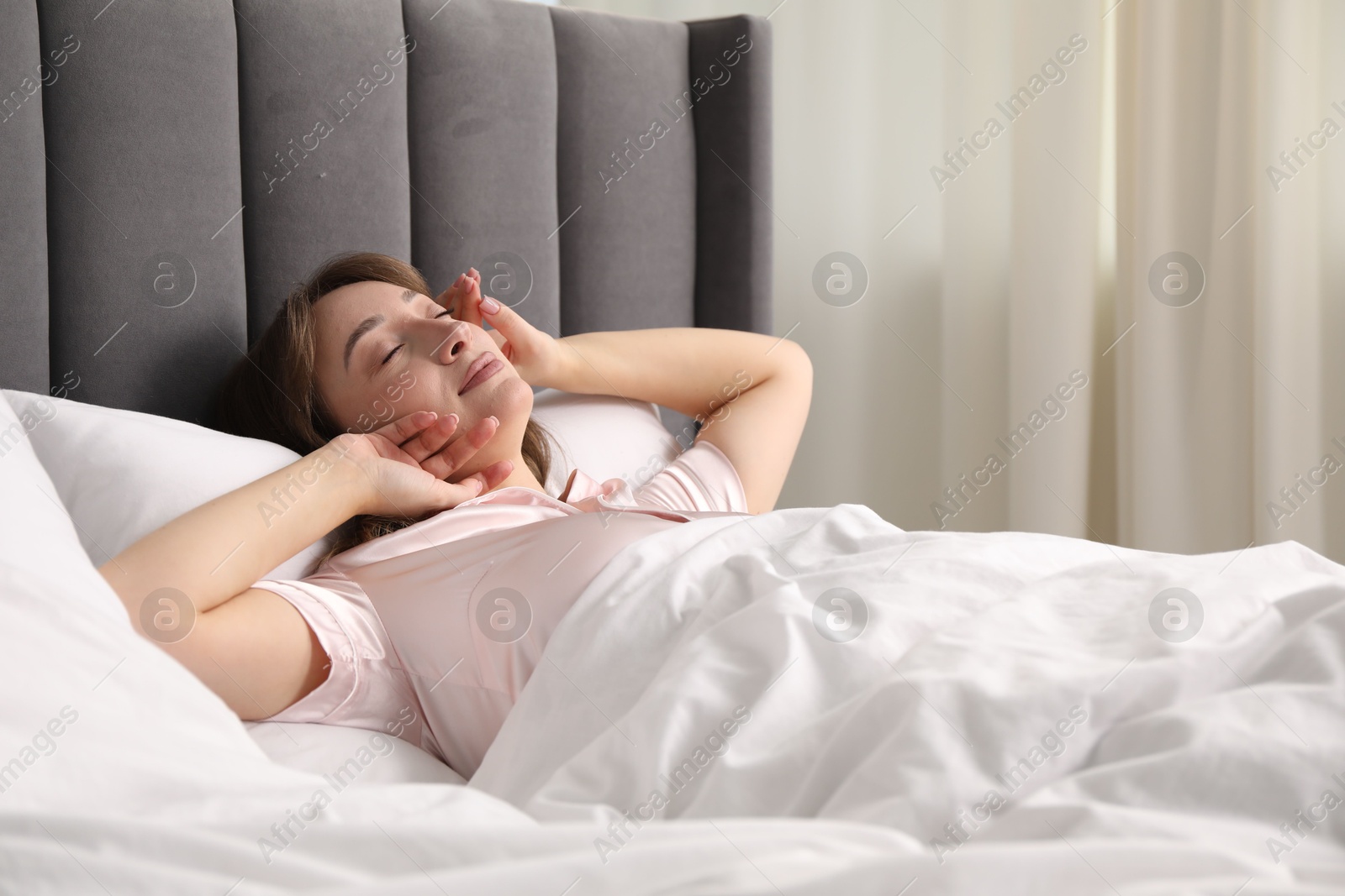 Beautiful woman sleeping in bed at home Photo of Beautiful woman sleeping in bed at home