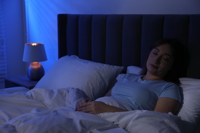 Photo of Beautiful woman sleeping in bed at home