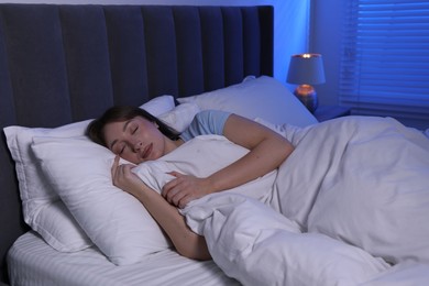 Photo of Beautiful woman sleeping in bed at home