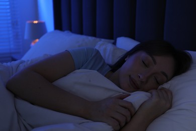 Photo of Beautiful woman sleeping in bed at home