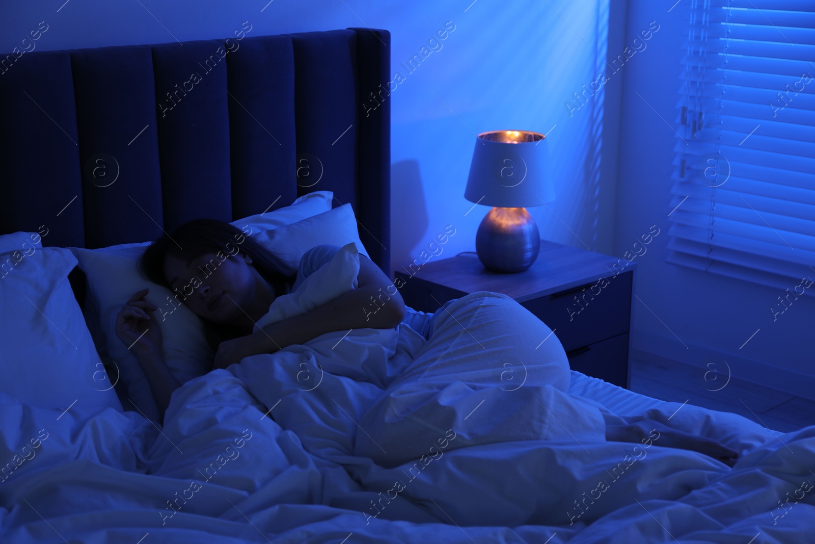 Beautiful woman sleeping in bed at home Photo of Beautiful woman sleeping in bed at home