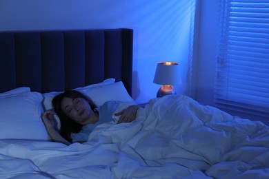 Photo of Beautiful woman sleeping in bed at home