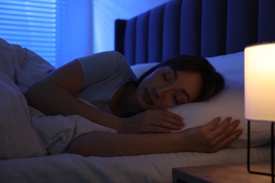 Photo of Beautiful woman sleeping in bed at home