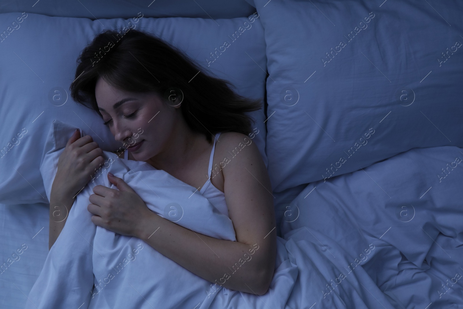 Beautiful woman sleeping in bed at home, top view Photo of Beautiful woman sleeping in bed at home, top view