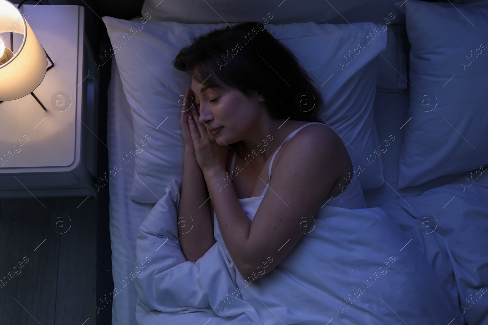 Beautiful woman sleeping in bed at home, top view Photo of Beautiful woman sleeping in bed at home, top view
