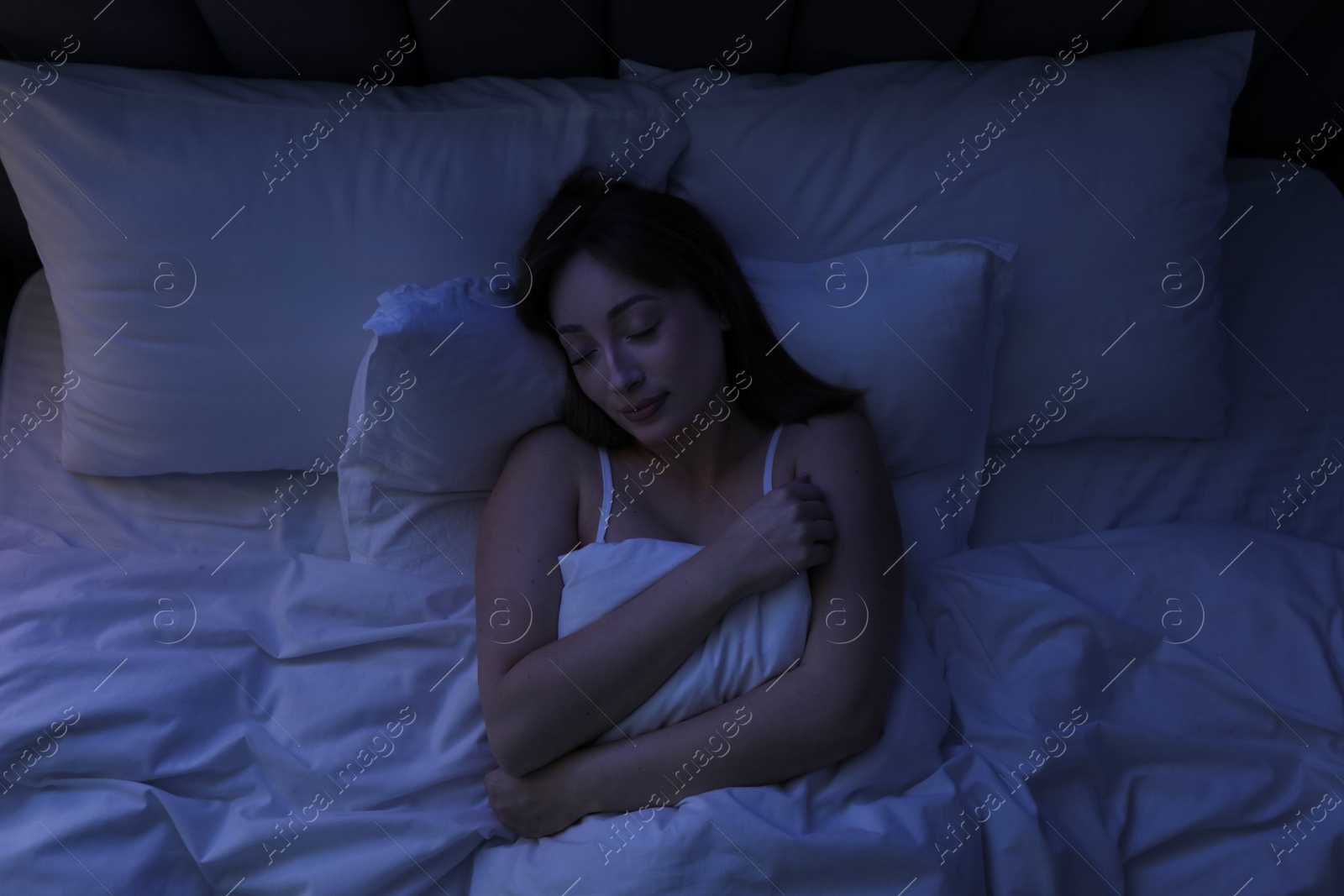 Beautiful woman sleeping in bed at home, top view Photo of Beautiful woman sleeping in bed at home, top view
