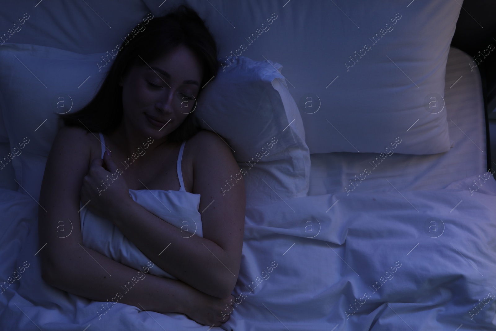 Beautiful woman sleeping in bed at home, top view Photo of Beautiful woman sleeping in bed at home, top view