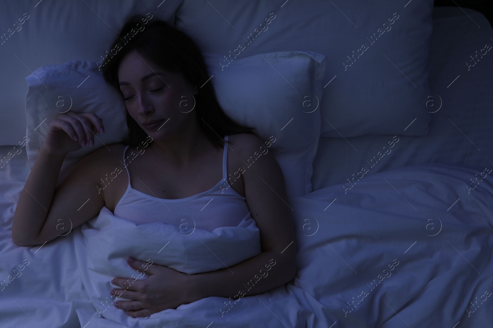Beautiful woman sleeping in bed at home, top view Photo of Beautiful woman sleeping in bed at home, top view