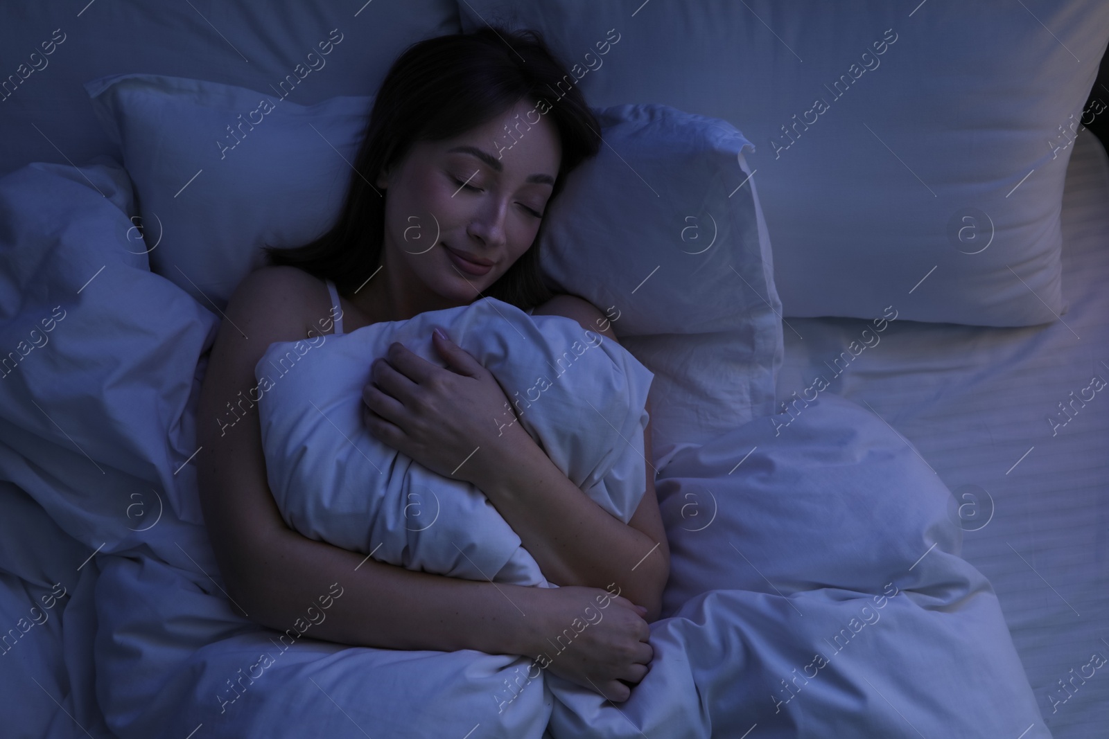 Beautiful woman sleeping in bed at home, top view Photo of Beautiful woman sleeping in bed at home, top view