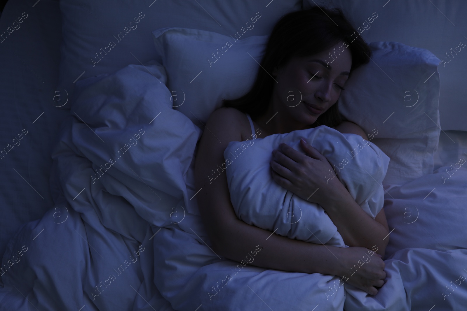 Beautiful woman sleeping in bed at home, top view Photo of Beautiful woman sleeping in bed at home, top view