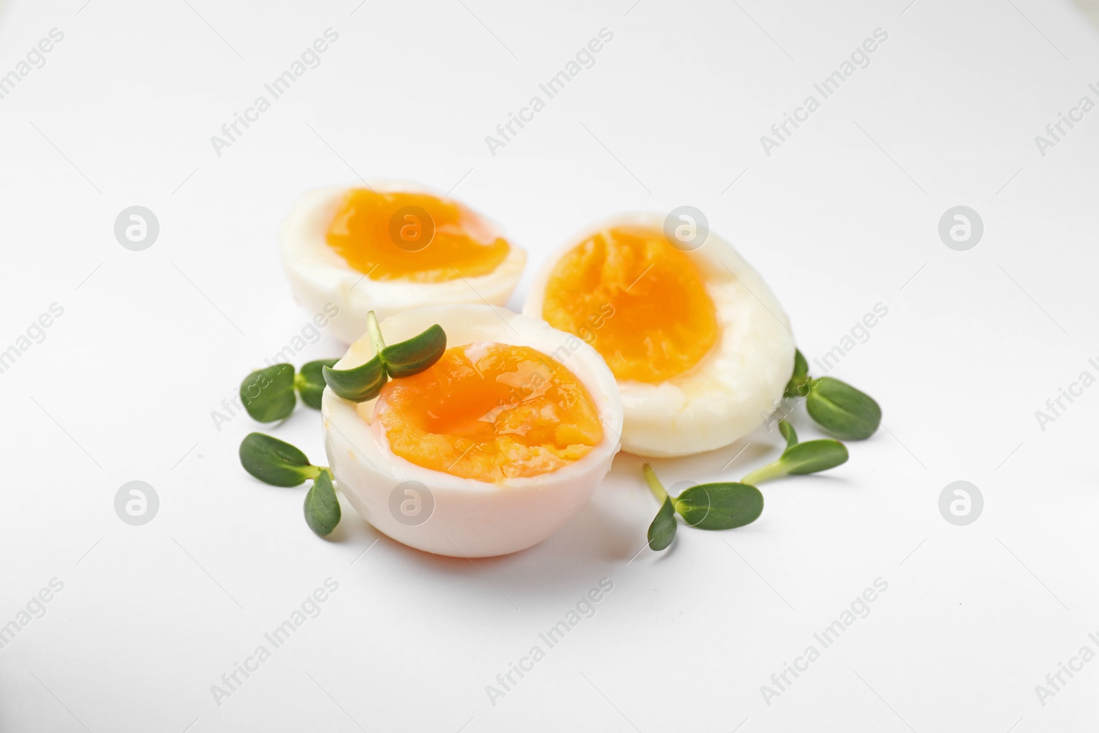 Soft boiled eggs with microgreens on white background Photo of Soft boiled eggs with microgreens on white background