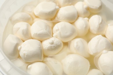 Photo of Tasty mozzarella cheese balls as background, closeup