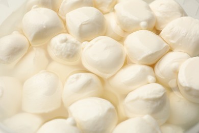 Photo of Tasty mozzarella cheese balls as background, closeup