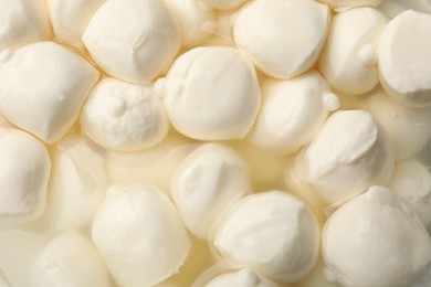 Photo of Tasty mozzarella cheese balls as background, closeup