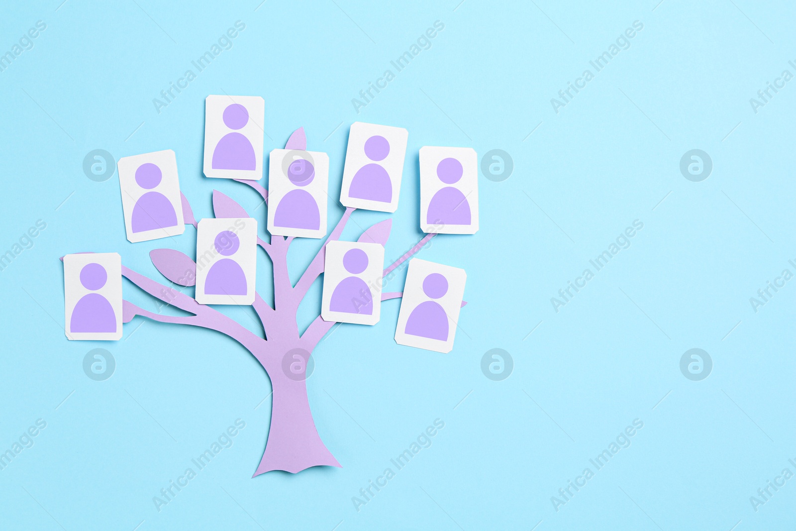 Family tree. Cards with human icons attached to paper tree on light blue background, top view. Space for text Image of Family tree. Cards with human icons attached to paper tree on light blue background, top view. Space for text