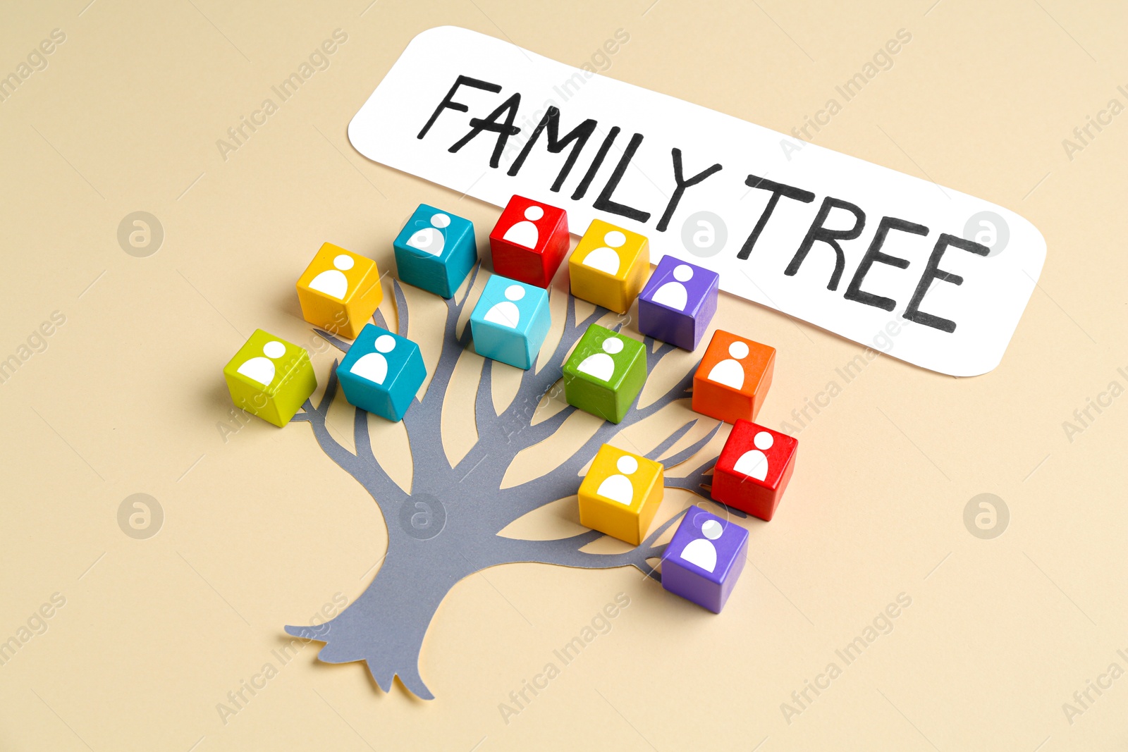 Family tree. Colorful cubes with human icons and paper tree on beige background Image of Family tree. Colorful cubes with human icons and paper tree on beige background