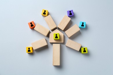 Image of Colorful cubes with human icons and wooden blocks compositing family tree on grey background, top view