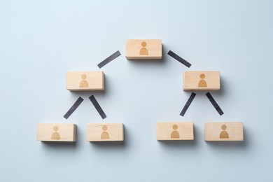 Image of Family tree. Scheme of wooden blocks with human icons on light background, top view