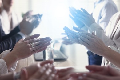 Image of Group of people applauding over table, double exposure