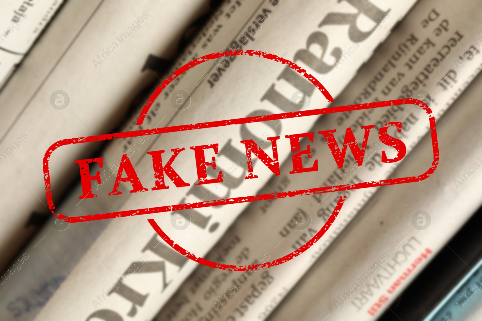 Red Fake News stamp and newspapers in different languages as background, closeup Image of Red Fake News stamp and newspapers in different languages as background, closeup
