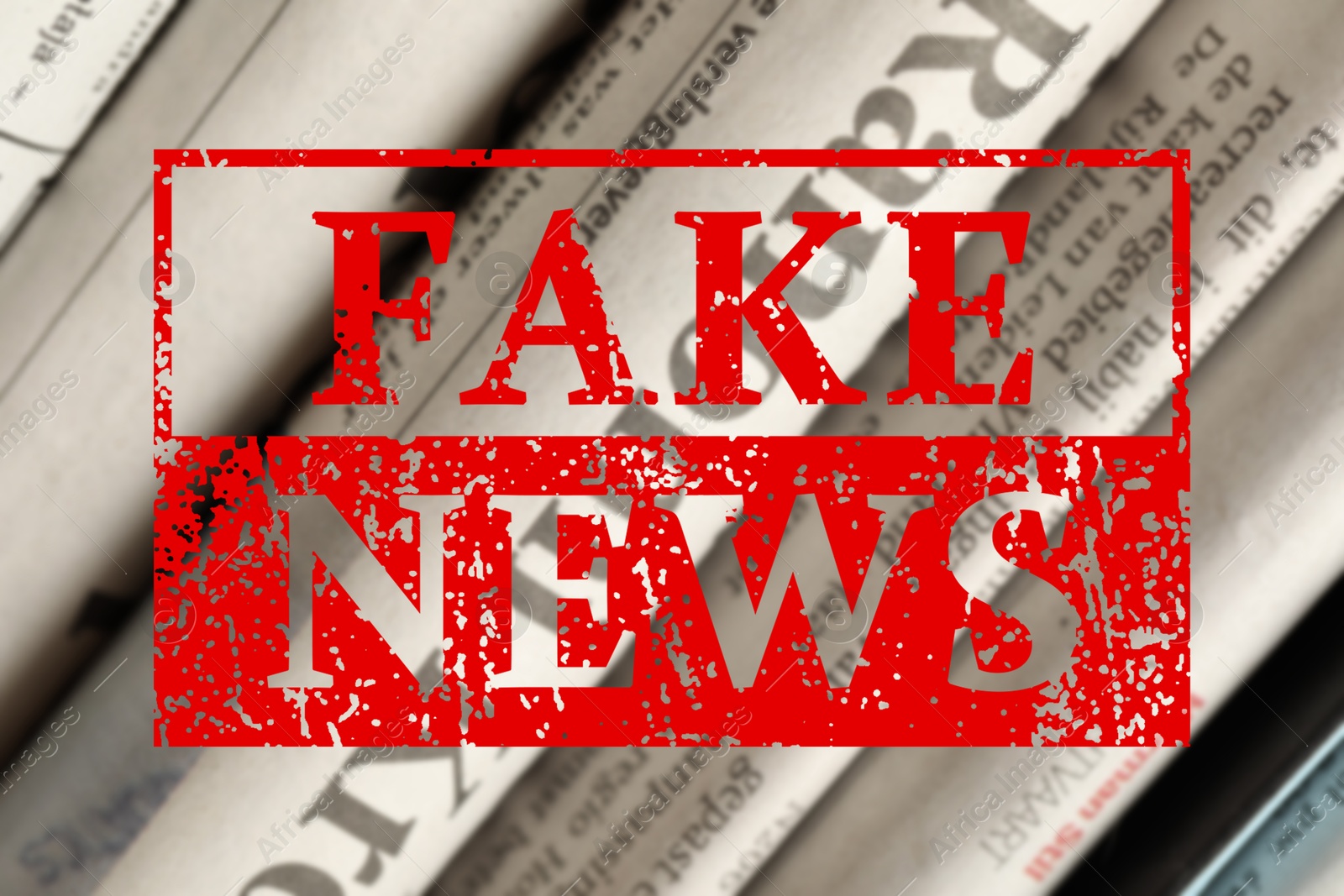 Red Fake News stamp and newspapers in different languages as background, closeup Image of Red Fake News stamp and newspapers in different languages as background, closeup