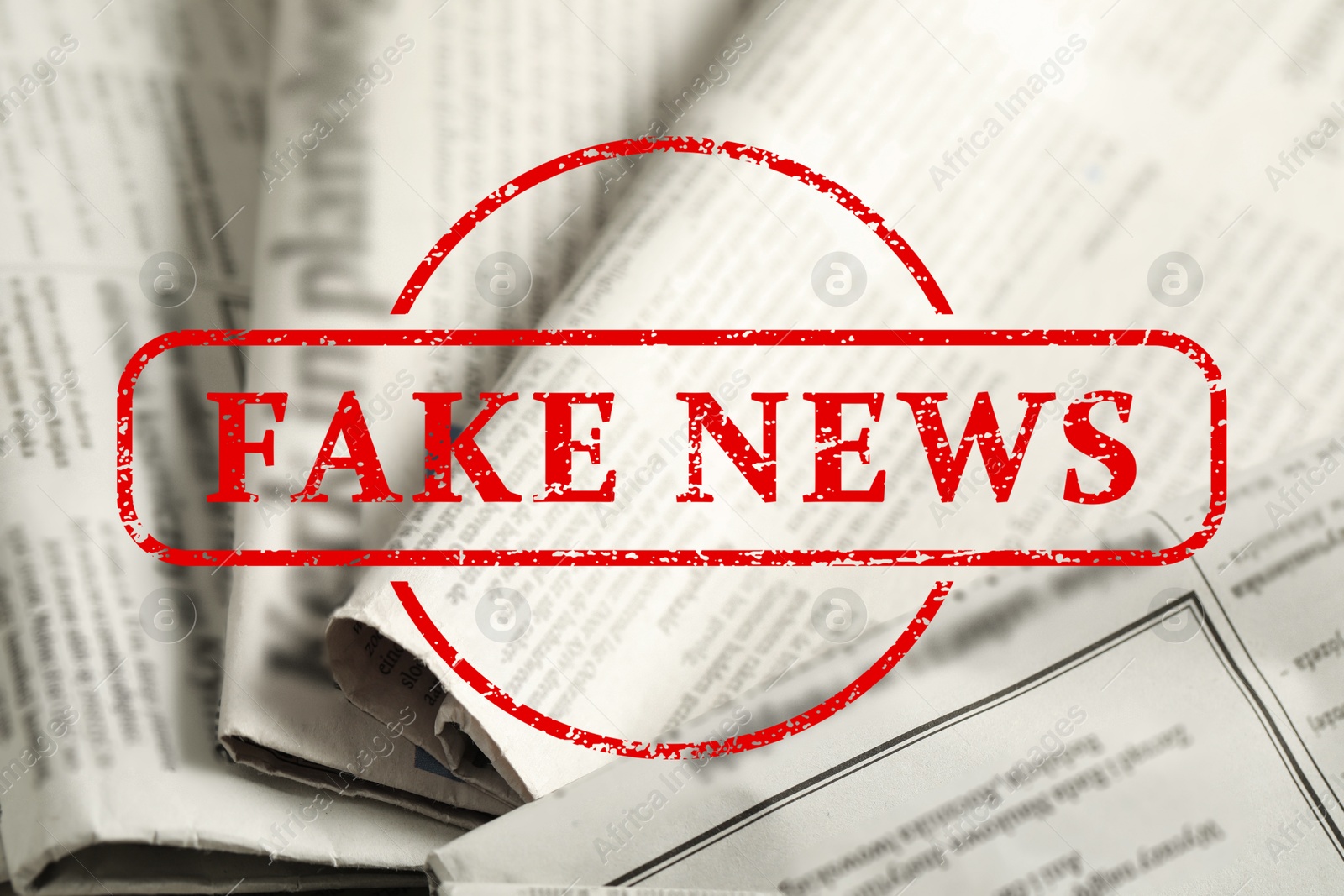 Red Fake News stamp and newspapers as background, closeup Image of Red Fake News stamp and newspapers as background, closeup
