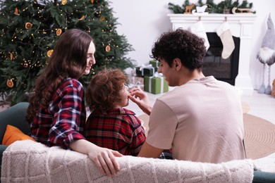 Photo of Family with popcorn spending time together at home. Watching movie via video projector